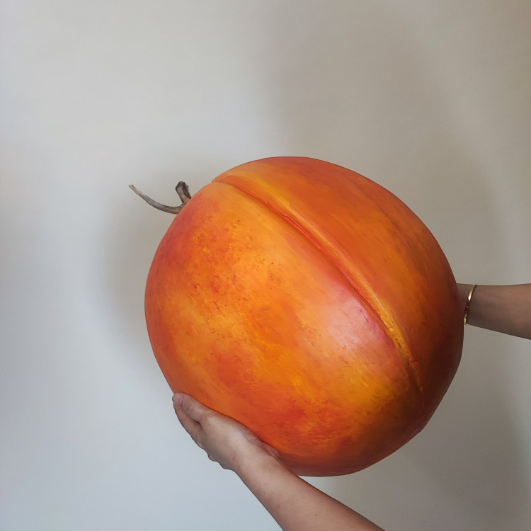 ماکت هلو سایز برزگ کخ با دو دست نگه داشته شده